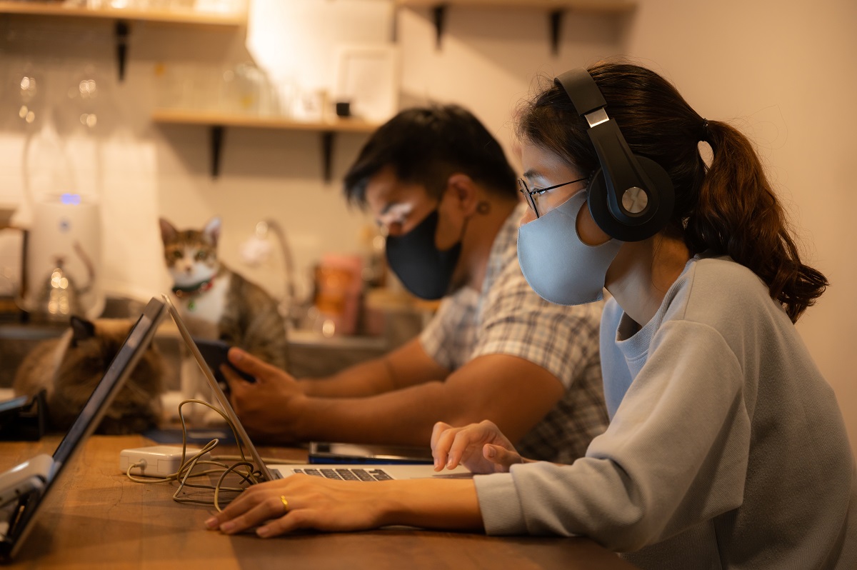 Creative Designer Business Worker, Working In Spaced And Wearing A Medical Face Mask To Prevent The Spread Of The Coronavirus Covid 2019, Home Office For Small People Group To Work From Home