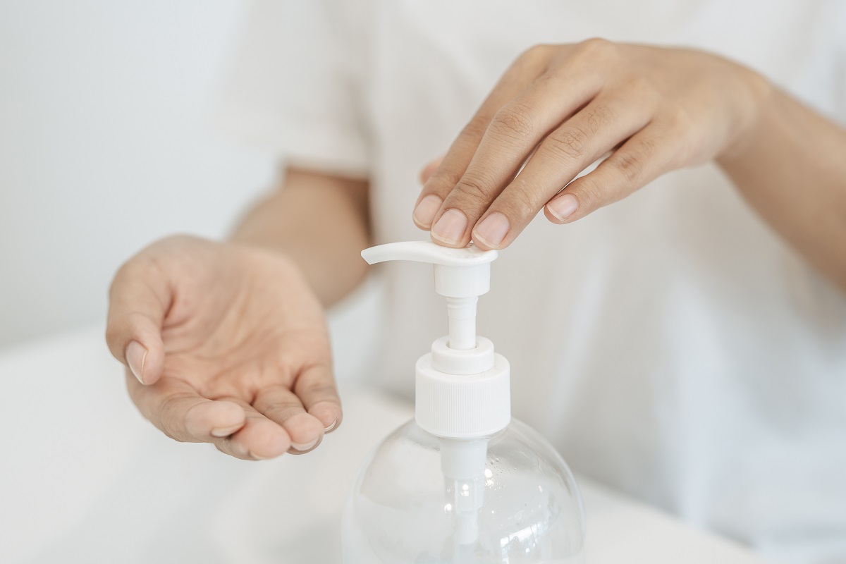 Women Wearing White Shirts That Press The Gel To Wash Hands To C