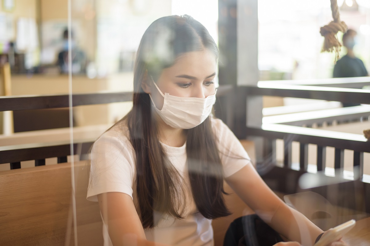 Woman Is Eating In Restaurant With Social Distancing Protocol While Lockdown City Due To Coronavirus Pandemic